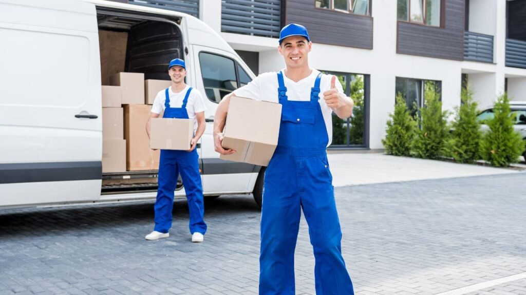 Two Professional Movers know carrying boxes is easier when you know how to pack a glass table top for moving