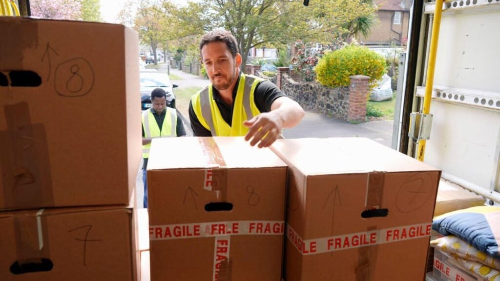 Burly Boyz movers loading boxes into a truck — how to relocate for a job made easier.