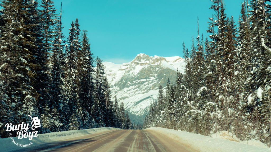 Snowy mountain road in Alberta during winter, ideal for planning your moving checklist Alberta