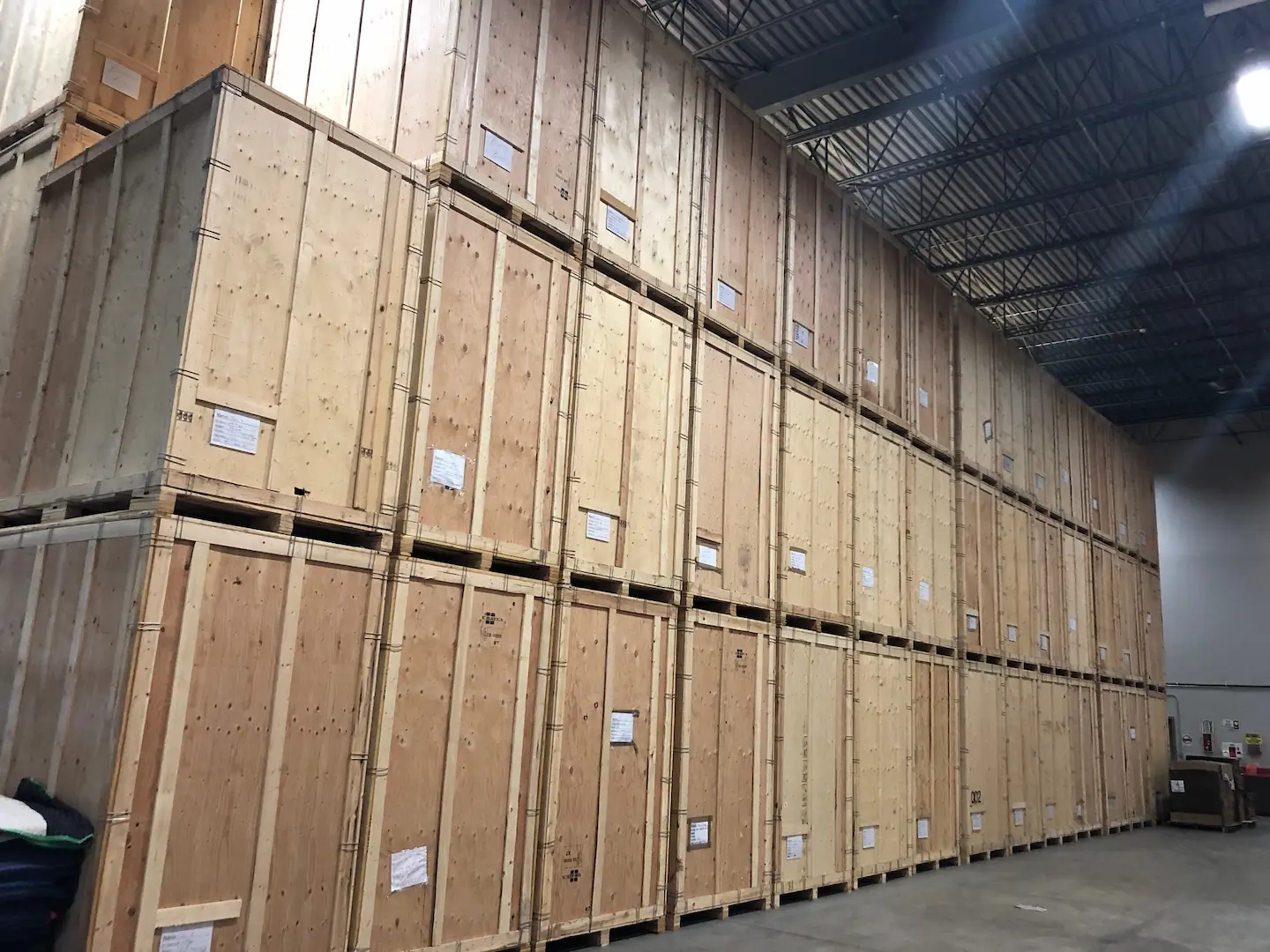 Stacked secure wooden storage crates inside Burly Boyz’s climate-controlled storage facility in Edmonton